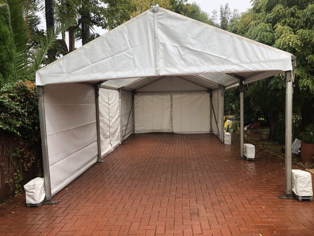 A photo of a marquee setup on paving.
